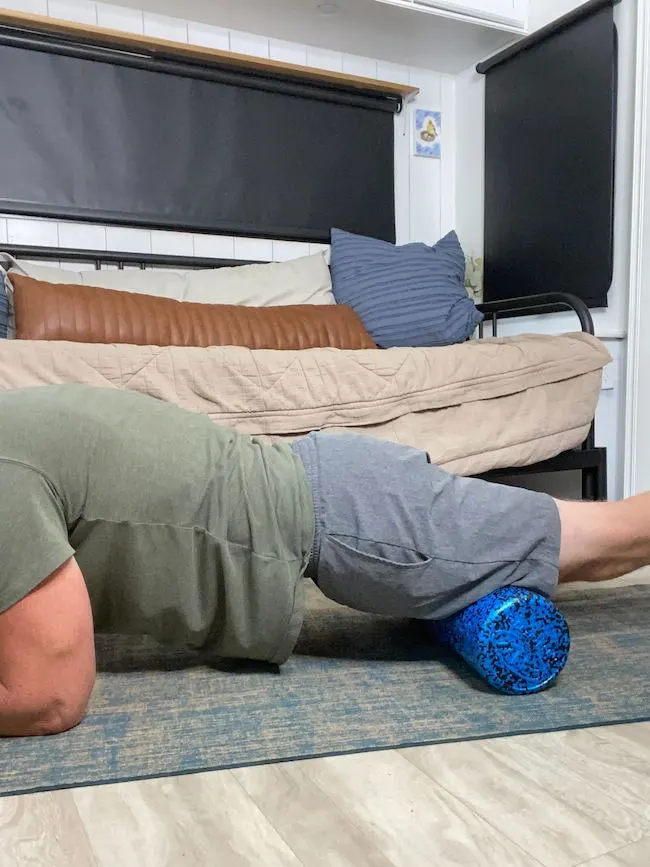 Coach Todd performing foam roll exercise for quads to alleviate sciatica pain by enhancing muscle recovery and reducing muscle tightness
