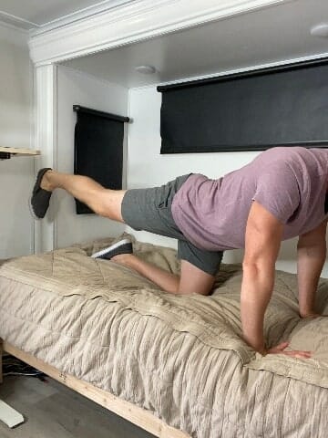 Coach todd showing quadruped leg extension exercise on the bed step 2