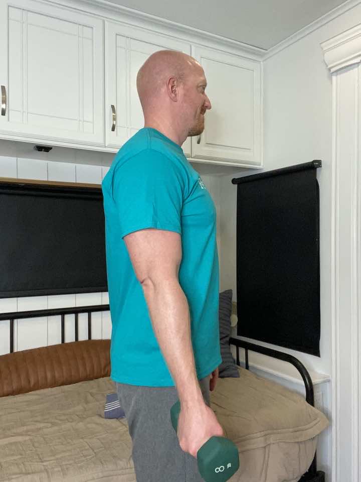 Executing bicep curls, a foundational exercise for strengthening arm muscles and supporting the elbow joint.