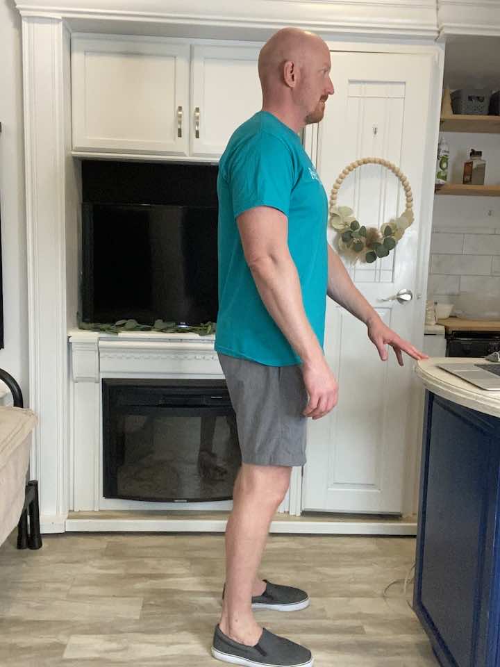 Coach Todd demonstrating the Standing Quad Stretch, a stretching routine designed to alleviate tightness in the quads for individuals with a Baker’s Cyst.