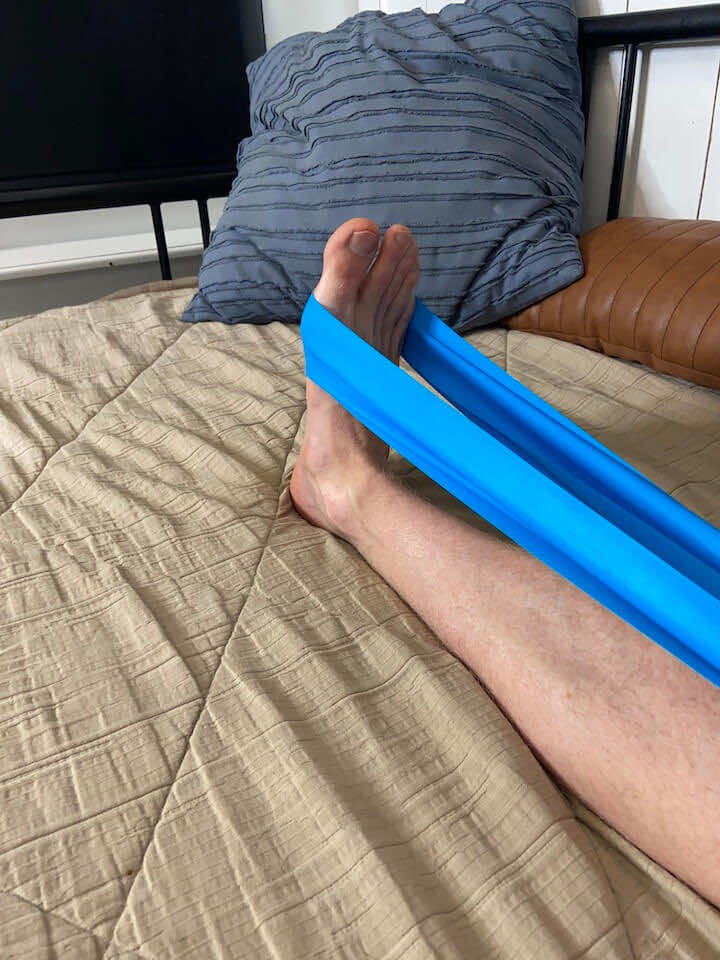 Engaging in ankle plantarflexion with a resistance band