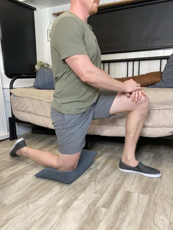 Coach Todd guiding through the Half Kneeling Hip Flexor Stretch, an exercise that intensely stretches the hip flexors and aids in managing psoas pain.