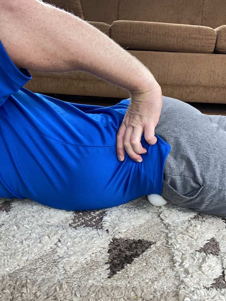 Coach Todd employing a ball for an Instant Psoas Release, a technique essential for quick alleviation of psoas muscle pain.